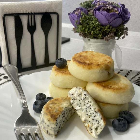 Cheesecakes with poppy seeds. 1 pc. Galettes from white and yellow cheese. 1 piece.