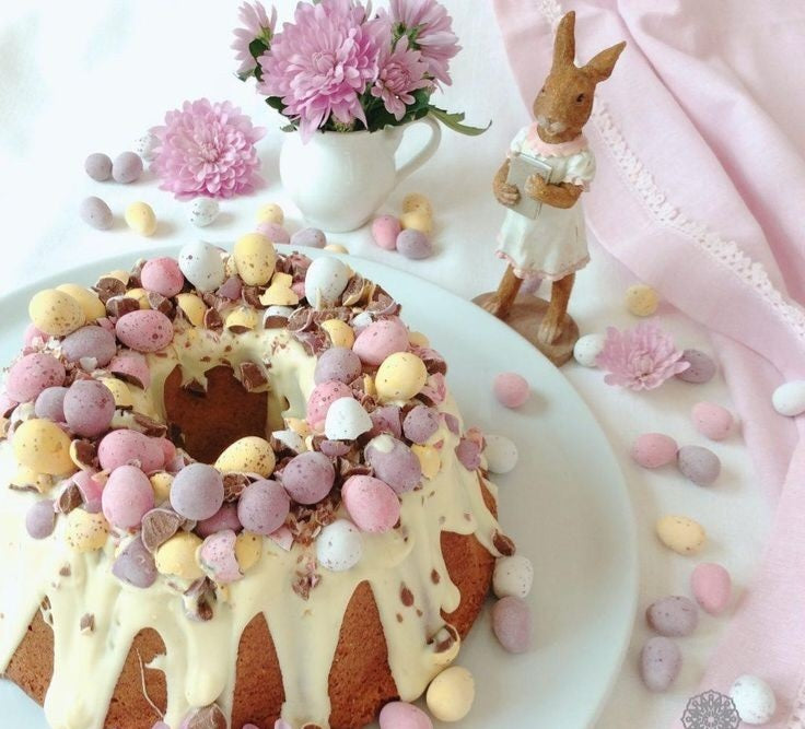 Easter cake with nuts and raisins, decorated with white chocolate and chocolate eggs.